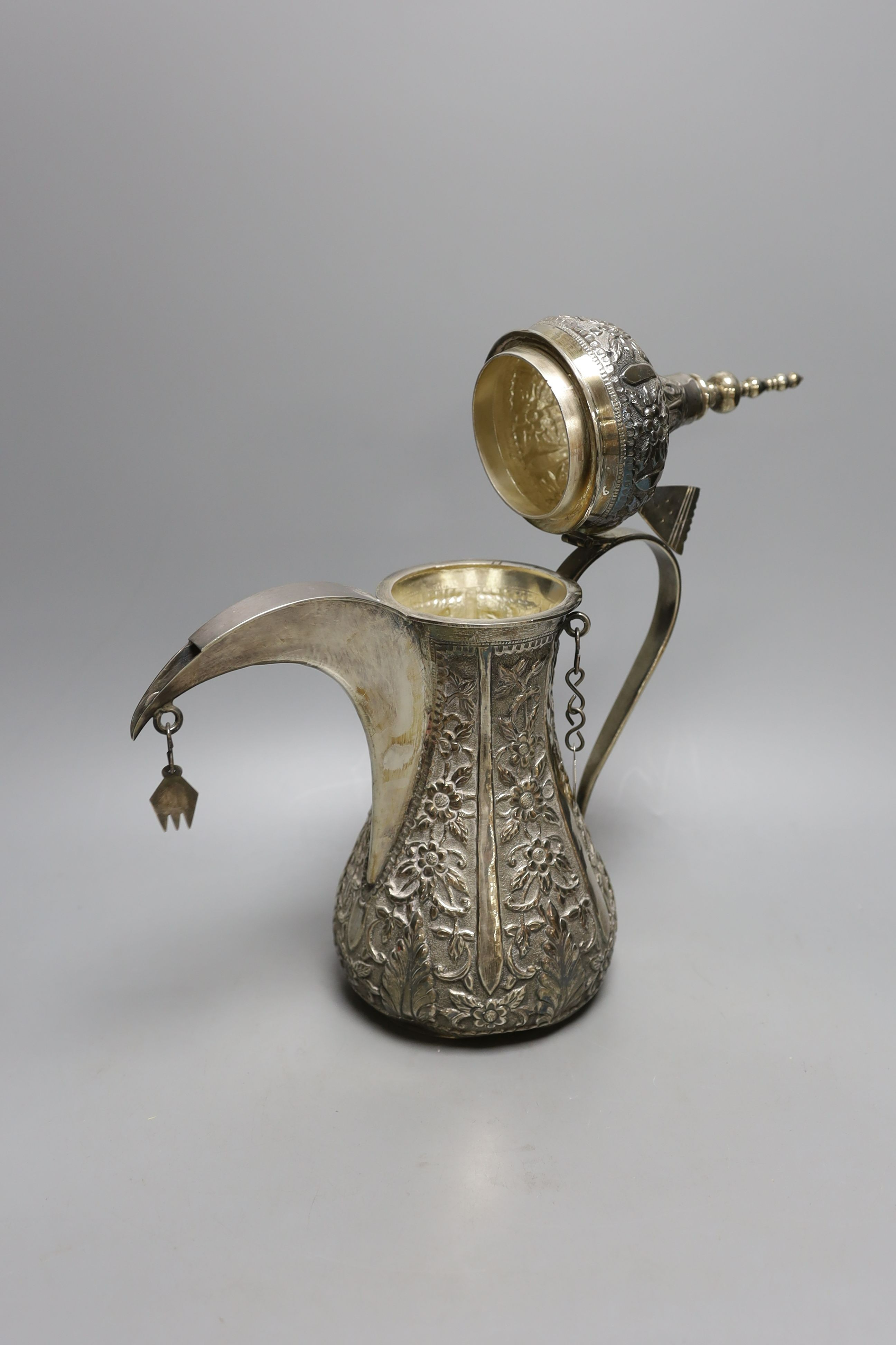 A Middle Eastern white metal dallah, height 36cm.